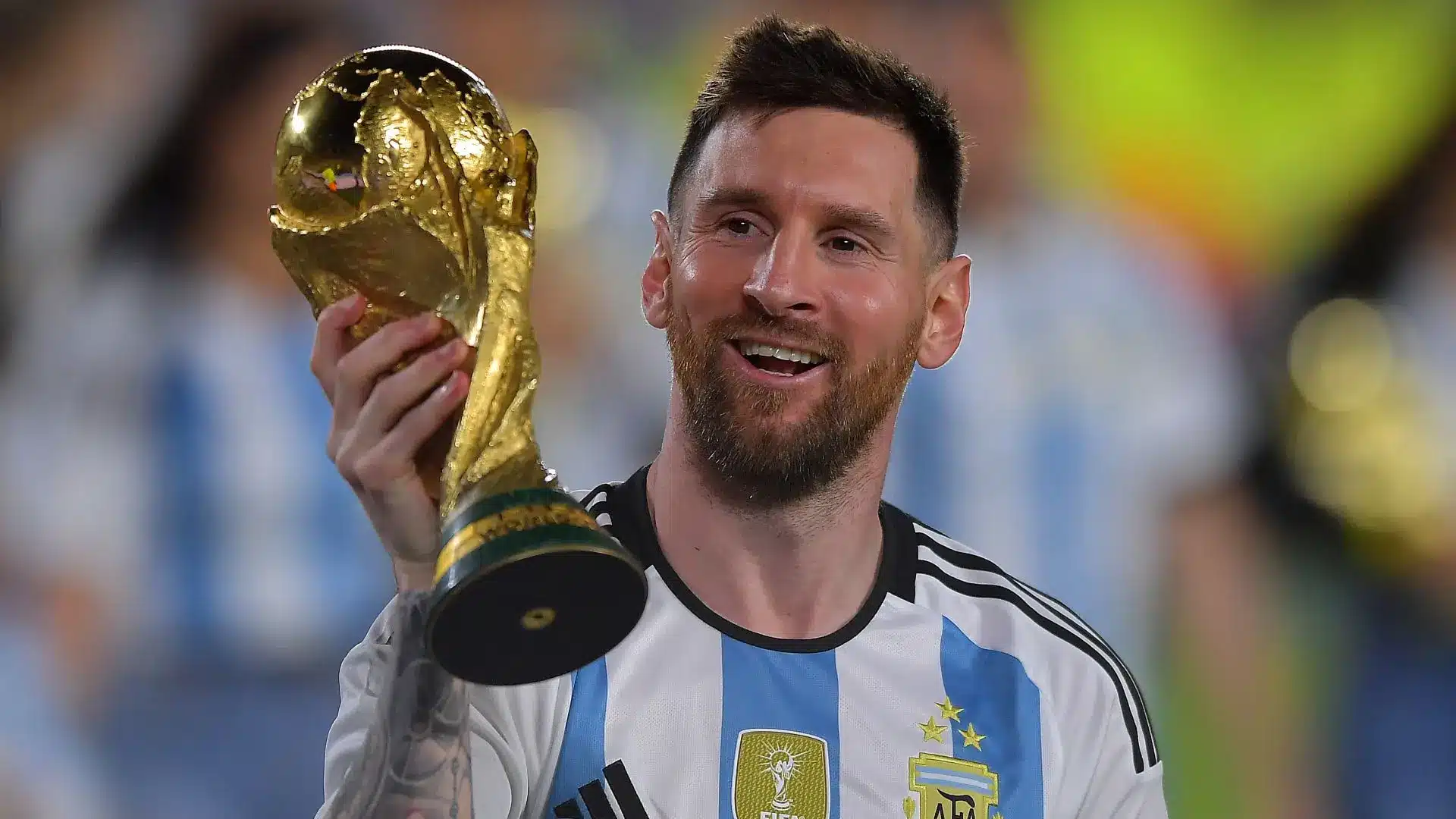 Lionel Messi celebrating with the FIFA World Cup trophy in Argentina jersey.