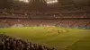 World Cup knockout stage match in packed stadium with dramatic lighting and intense crowd atmosphere