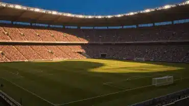 World Cup stadium with packed stands and illuminated pitch at golden hour