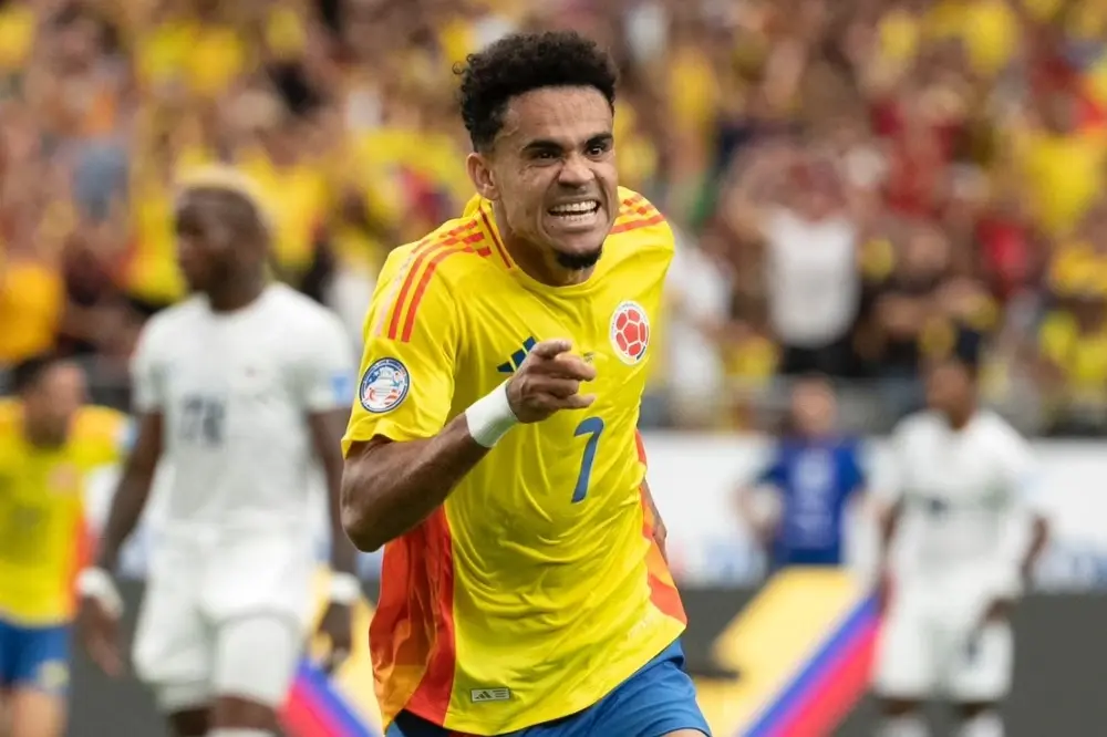 Luis Diaz celebrates wearing the yellow Colombia national team jersey during a match.