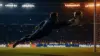 Goalkeeper making dramatic save during World Cup match under stadium lights