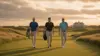 Three professional golfers walking together at Shinnecock Hills golf course at sunrise during US Open