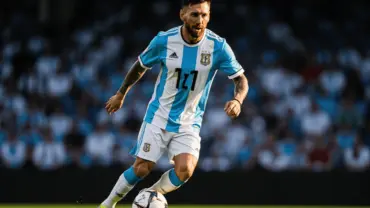 Lionel Messi in Argentina jersey controlling soccer ball during World Cup match action shot