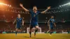 Soccer player celebrating goal at packed World Cup stadium with dramatic lighting and crowd