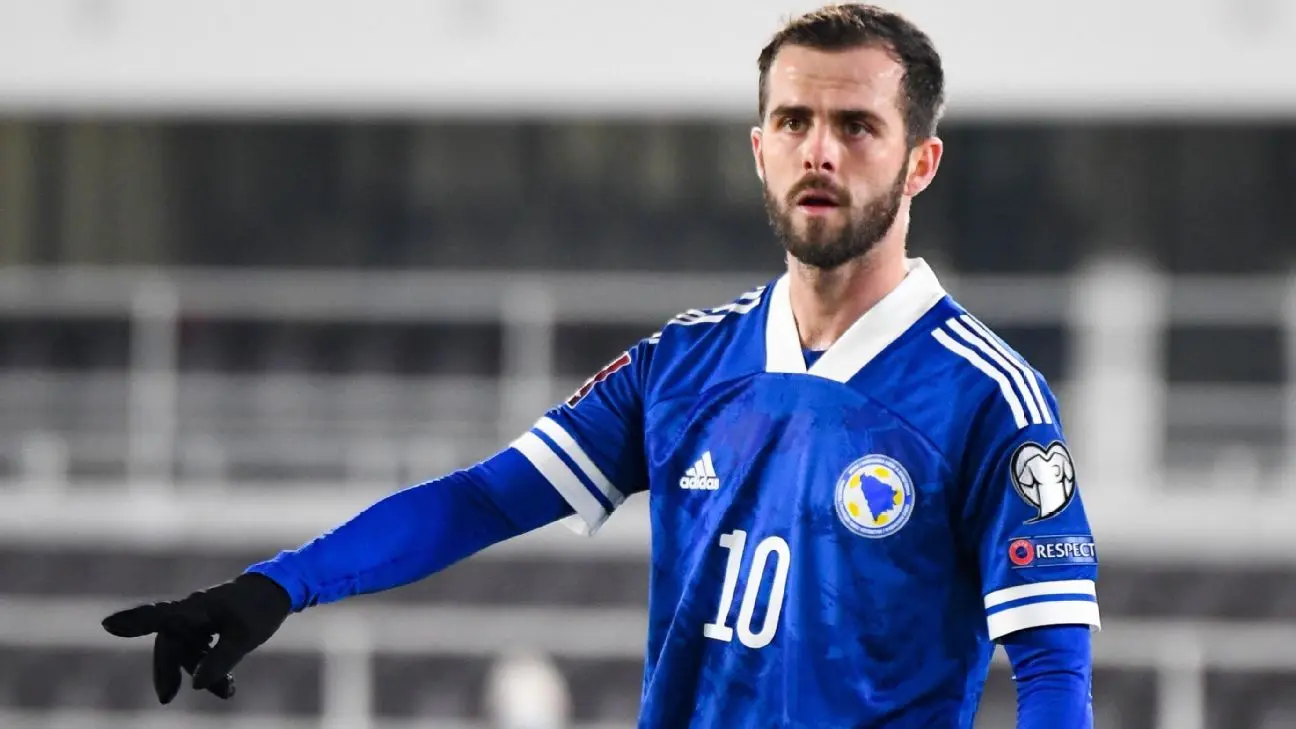 Miralem Pjanic in a blue Bosnia and Herzegovina soccer jersey during a match.