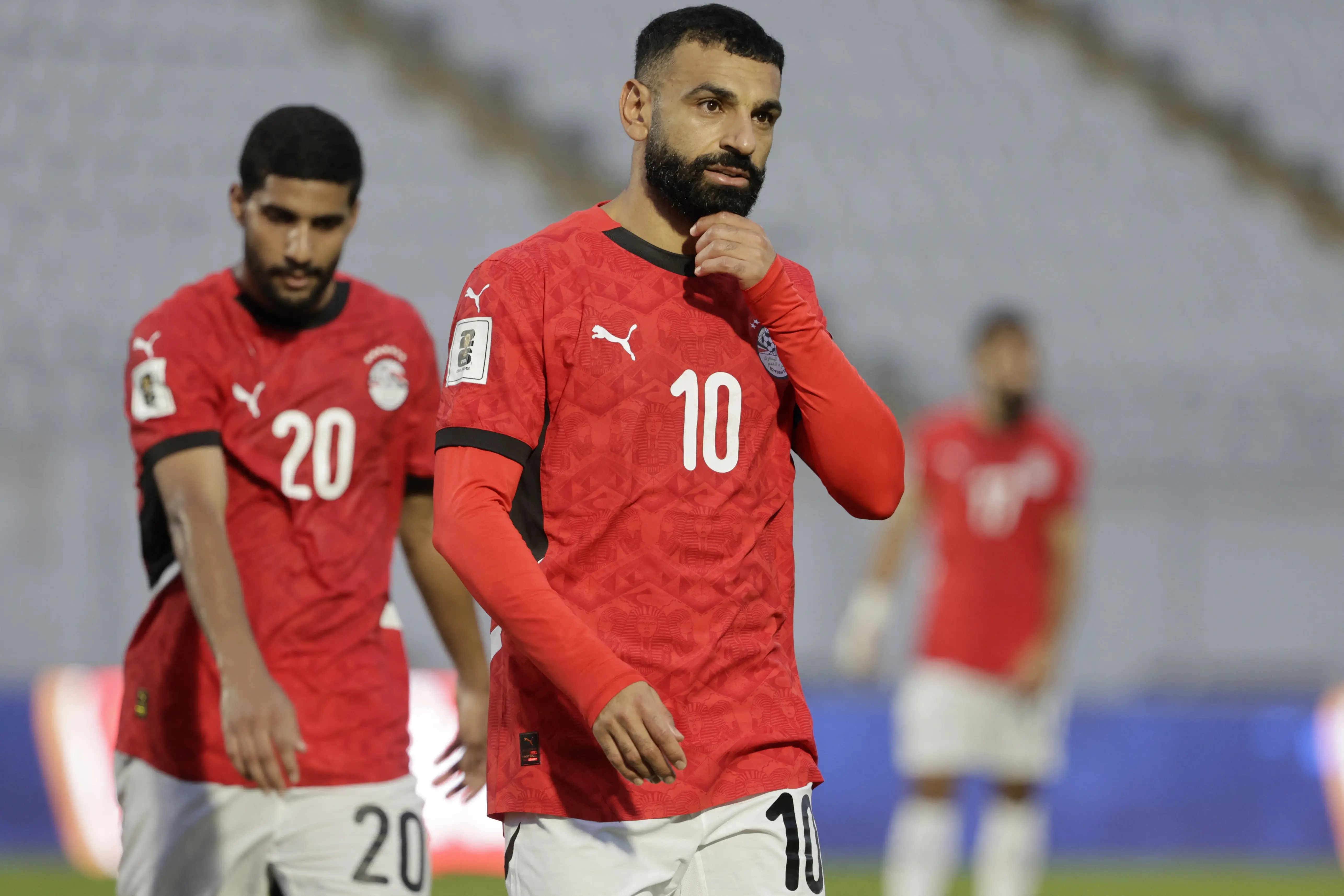 Egyptian national football team players in red jerseys on the field.