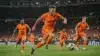 Netherlands attacking players in orange jerseys during intense World Cup match action