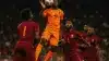 Netherlands striker competing for header against Morocco defenders in World Cup knockout match