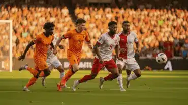 Netherlands soccer team attacking Tunisia's goal during World Cup 2026 Group F match in orange jerseys