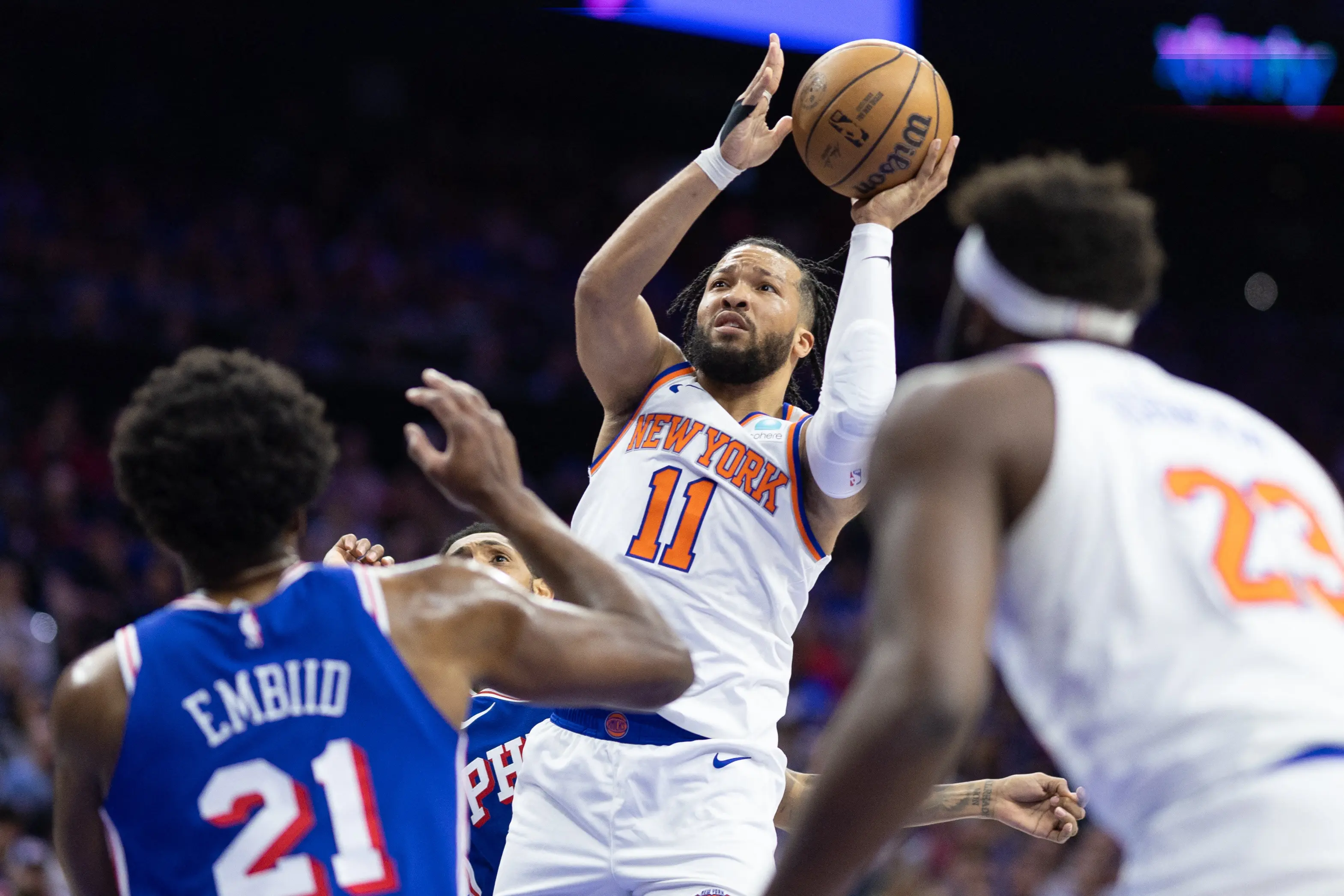 New York Knicks player shooting during an NBA game against Philadelphia.