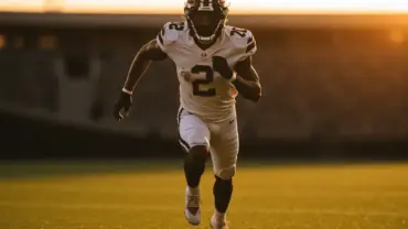 NFL second-year player in action on football field during golden hour