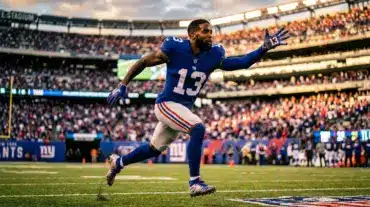 Odell Beckham Jr. in New York Giants uniform reaching for catch at MetLife Stadium