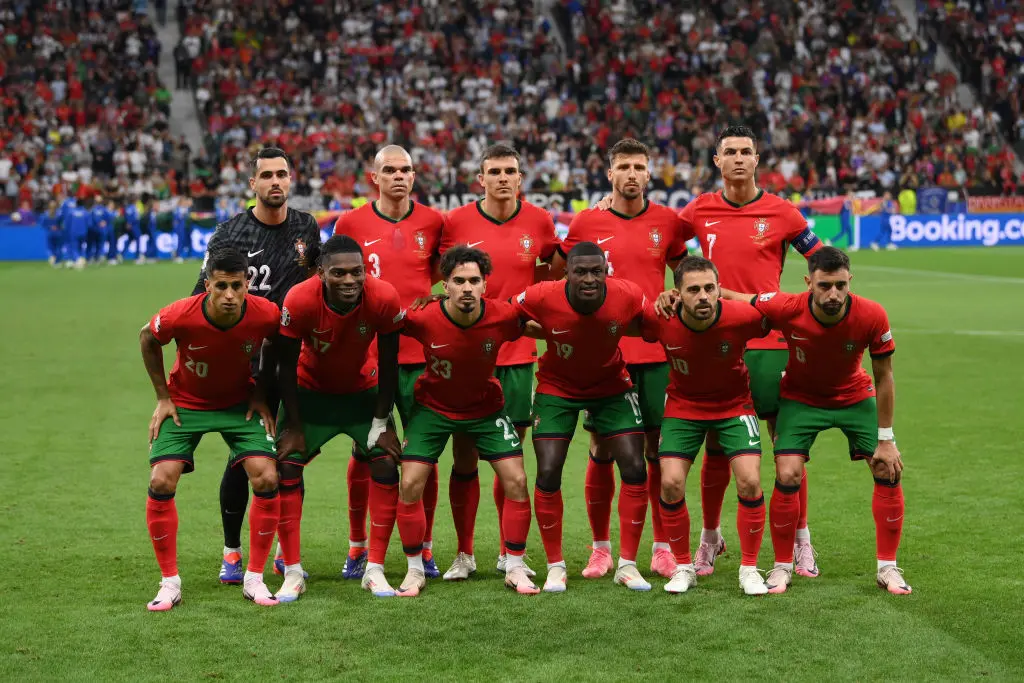 Portugal national football team players posing together on the field.