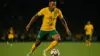 Brazilian soccer player in yellow jersey attacking with ball during World Cup match under stadium lights
