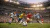Packed stadium during FIFA World Cup 2026 match with players competing on the pitch under dramatic lighting