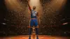 Knicks player celebrating NBA championship with triumphant gesture on confetti-filled court