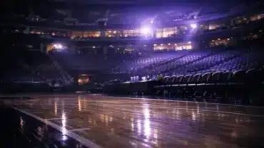Empty Sacramento Kings basketball court with dramatic purple lighting suggesting major roster changes