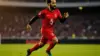 Mohamed Salah in Egypt jersey sprinting during World Cup match action against blurred stadium background