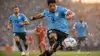 Uruguay soccer players in sky blue jerseys attacking during World Cup match at stadium