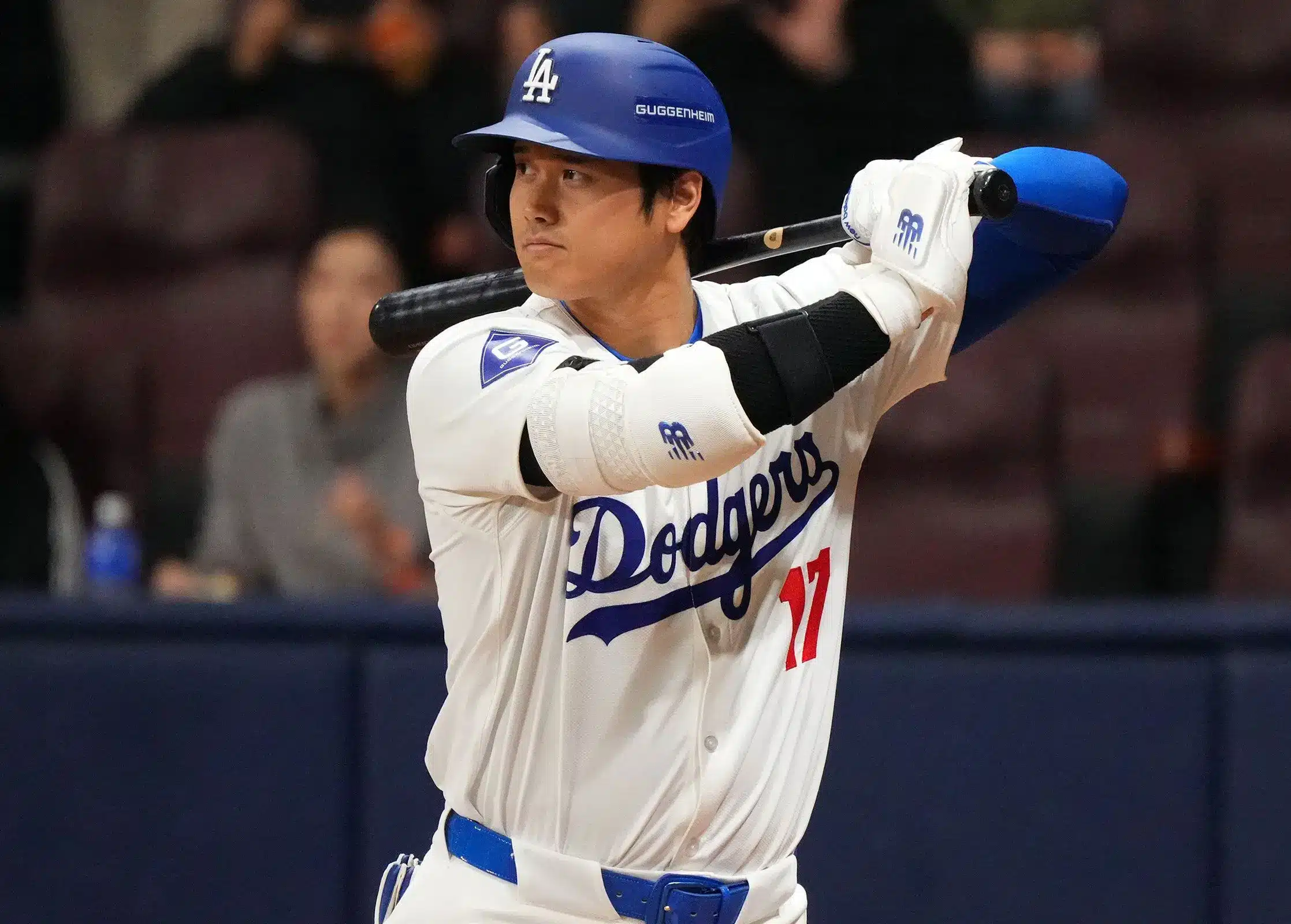 Shohei Ohtani in a Los Angeles Dodgers uniform, preparing to bat.