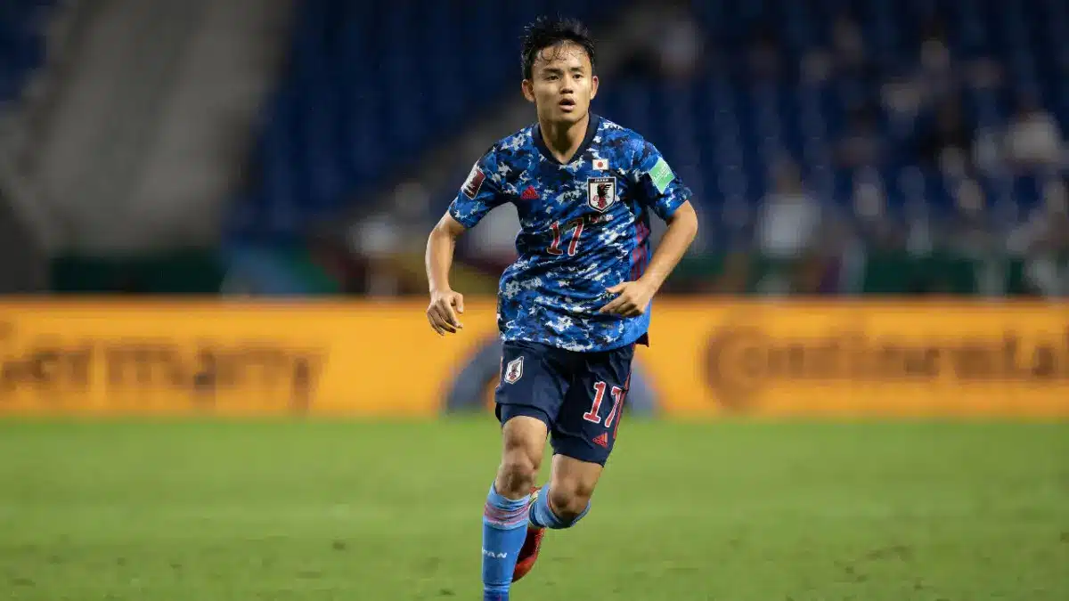 Takefusa Kubo wearing Japan national team kit during a match.