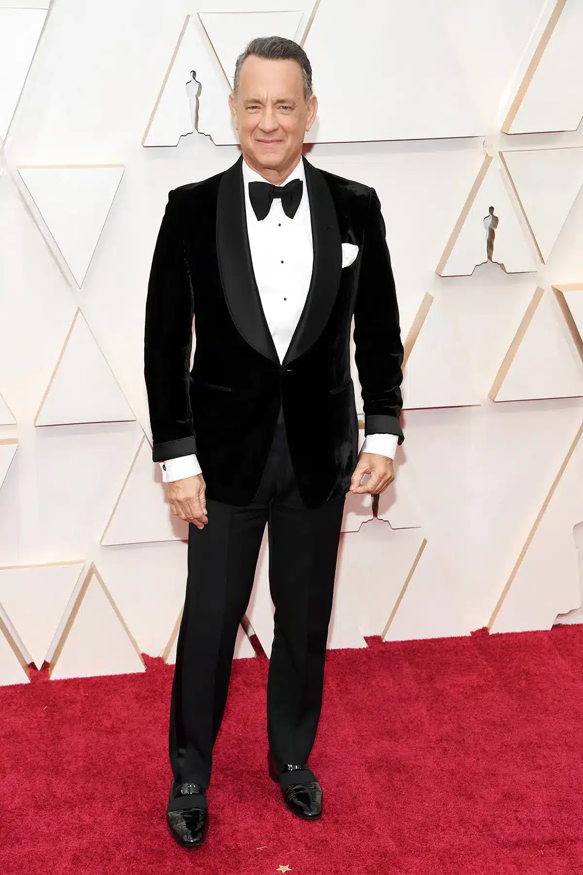 Tom Hanks in a tuxedo at the Oscars red carpet event.