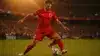 Turkish soccer player shooting during World Cup match under stadium lights