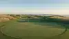 Shinnecock Hills golf course scenic view with fairway and green at golden hour