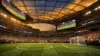 SoFi Stadium interior during soccer match with dramatic lighting and packed crowd