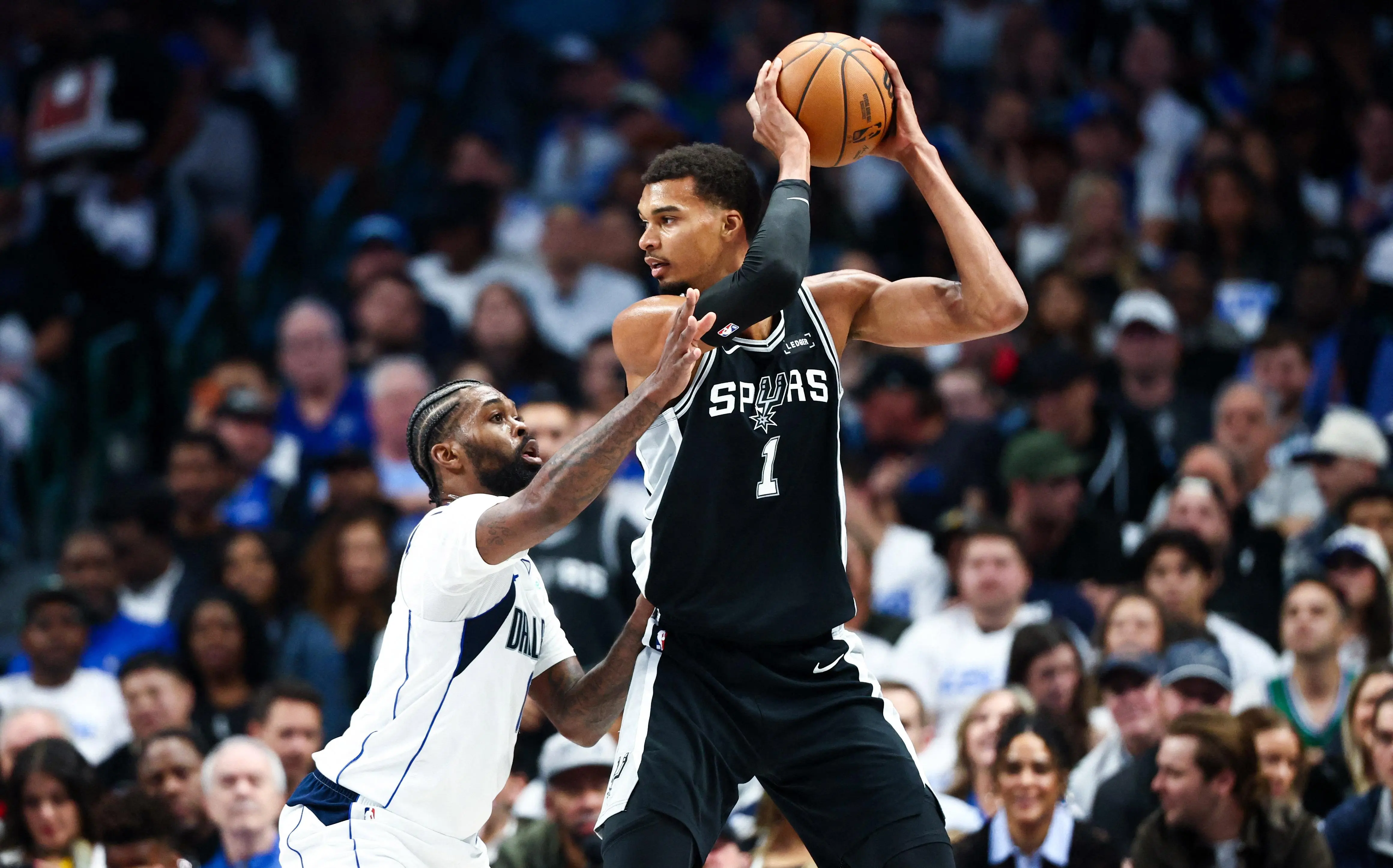 Victor Wembanyama of the San Antonio Spurs holding a basketball during a game.