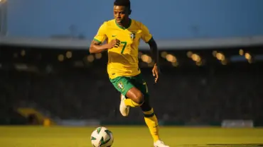 Vinícius Júnior in Brazil yellow jersey sprinting with ball during World Cup match