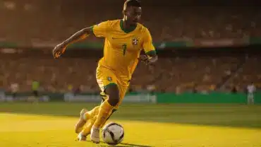 Brazilian soccer player in yellow jersey dribbling during intense World Cup match action