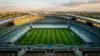 Aerial view of empty World Cup stadium at golden hour showing strategic field layout