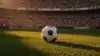 Soccer ball on stadium pitch with international flags at World Cup tournament golden hour