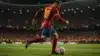 Spanish soccer player in red jersey attacking with ball under stadium lights at World Cup match