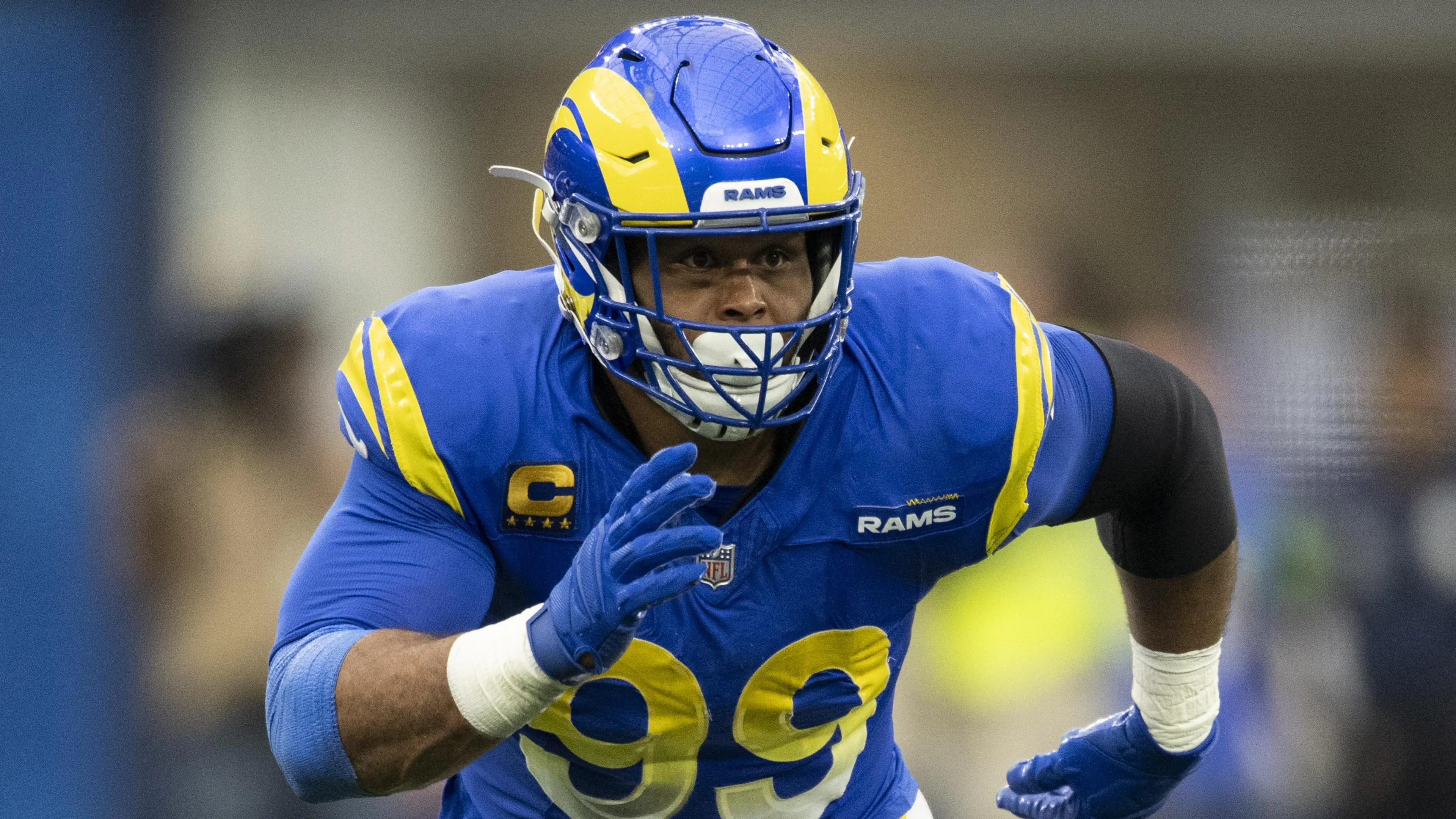 Aaron Donald wearing a blue Rams uniform, #99, during a game.