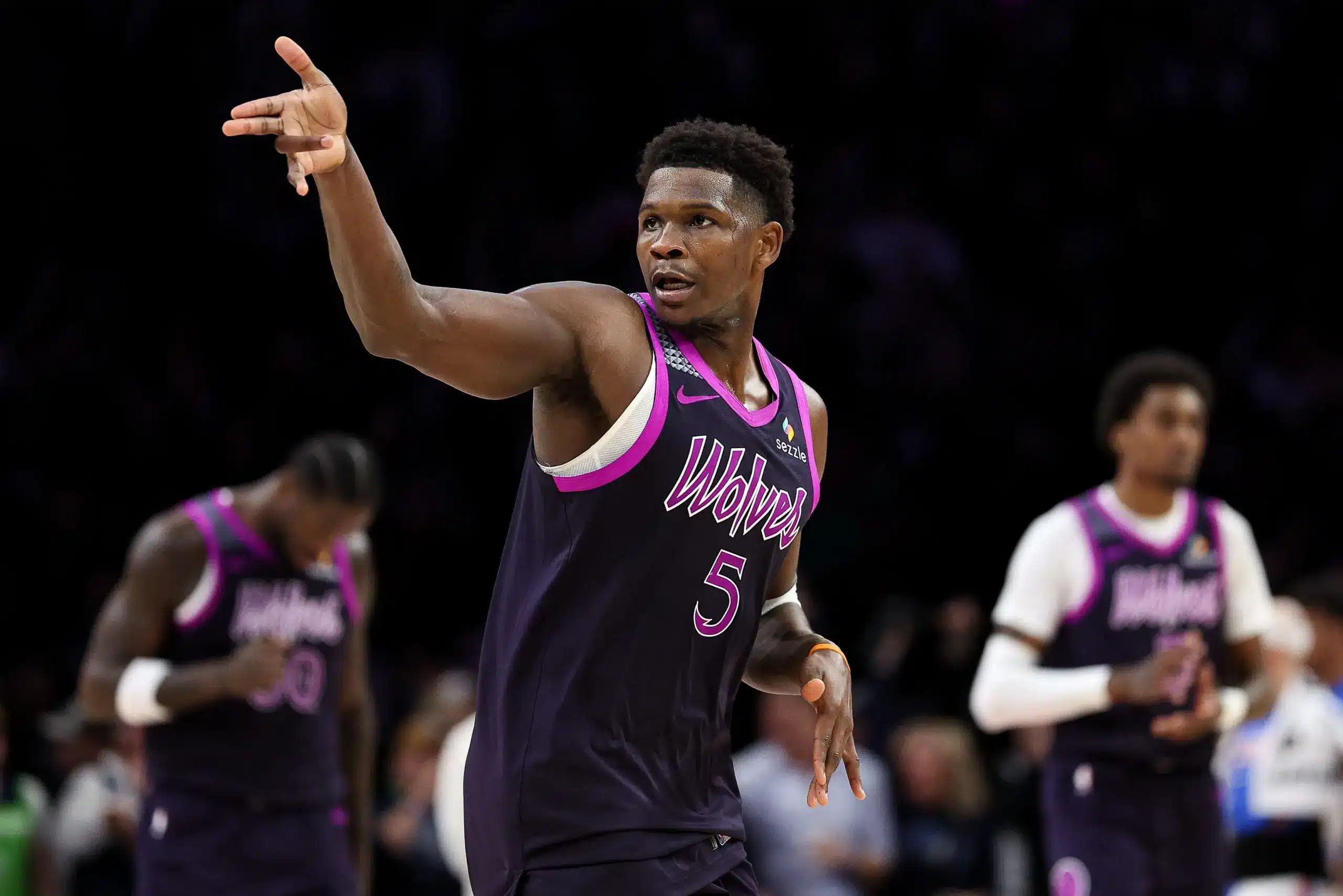 Anthony Edwards in purple Wolves uniform gestures during a game.
