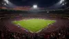 Packed World Cup stadium with illuminated pitch and crowd in team colors during knockout match