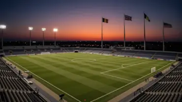 Illuminated soccer stadium at dusk during World Cup tournament with national flags