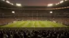 World Cup knockout stage match in packed stadium with dramatic evening lighting