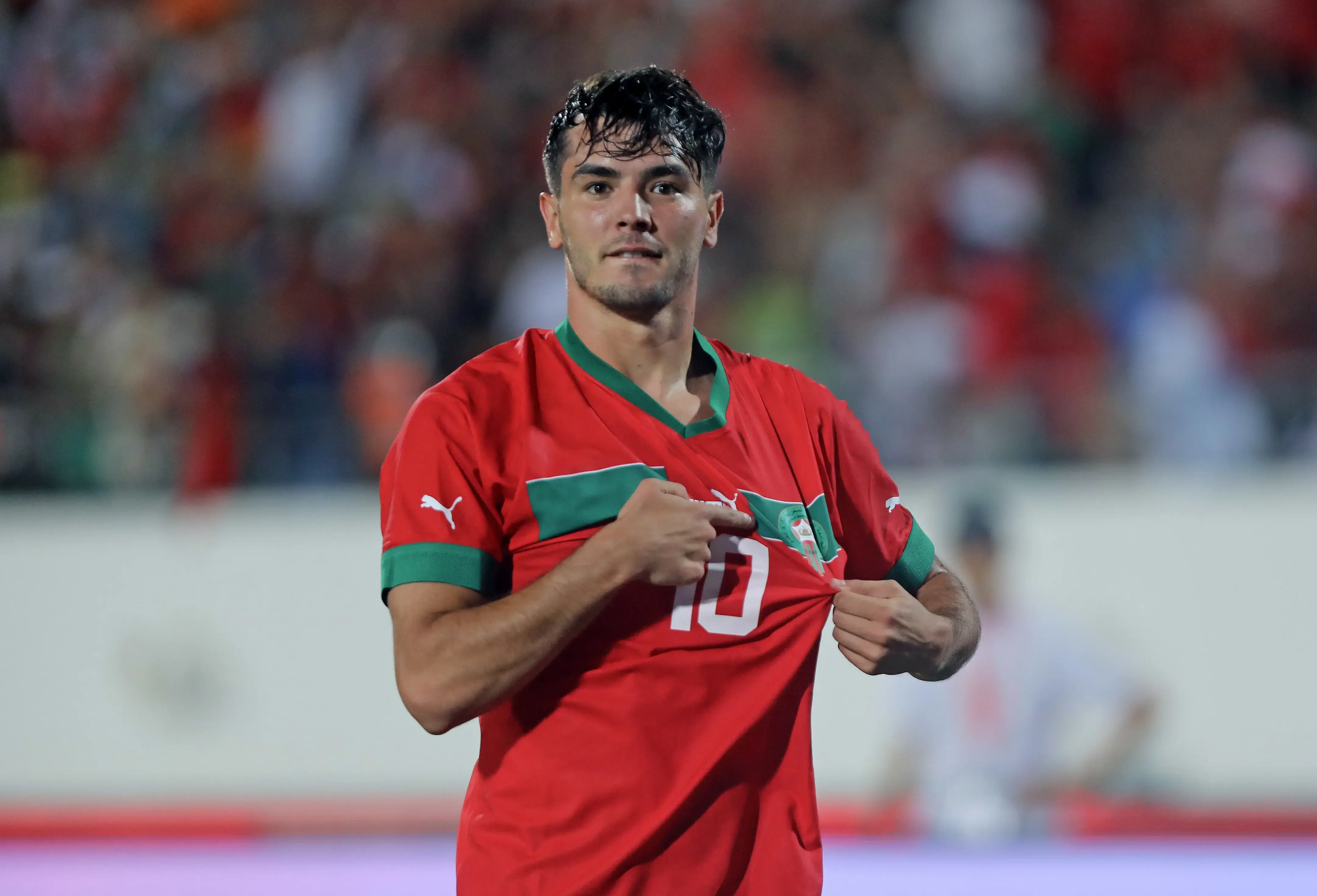 Brahim Diaz wearing the Moroccan national team jersey, celebrating with pride.