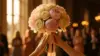 Bridal bouquet being caught at elegant wedding reception with soft romantic lighting