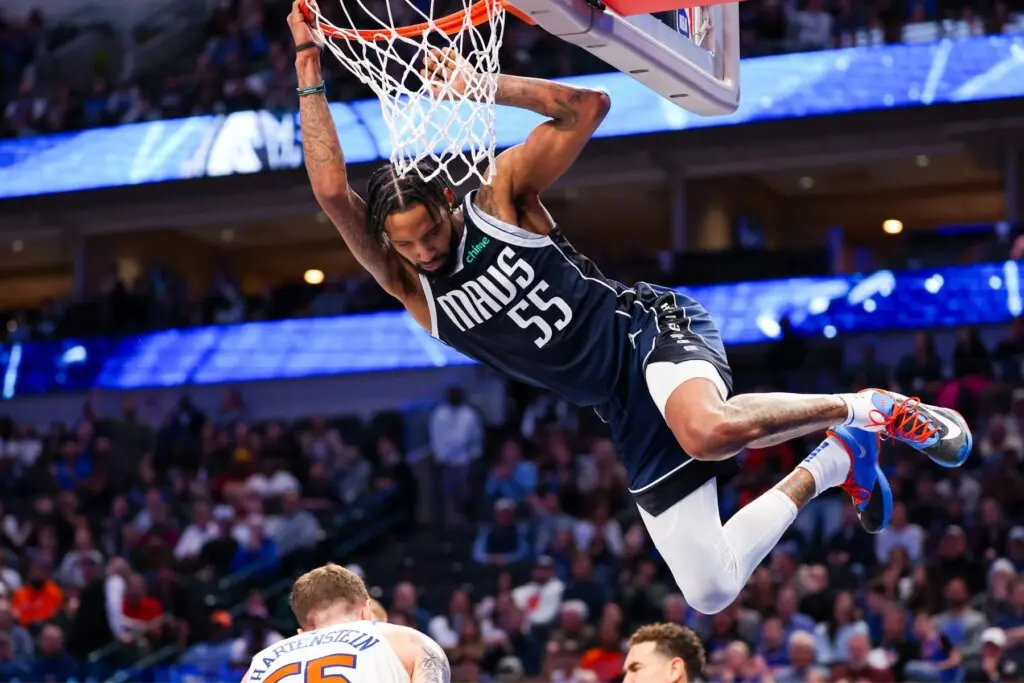 Derrick Jones Jr. performing a dunk during a Mavericks game.