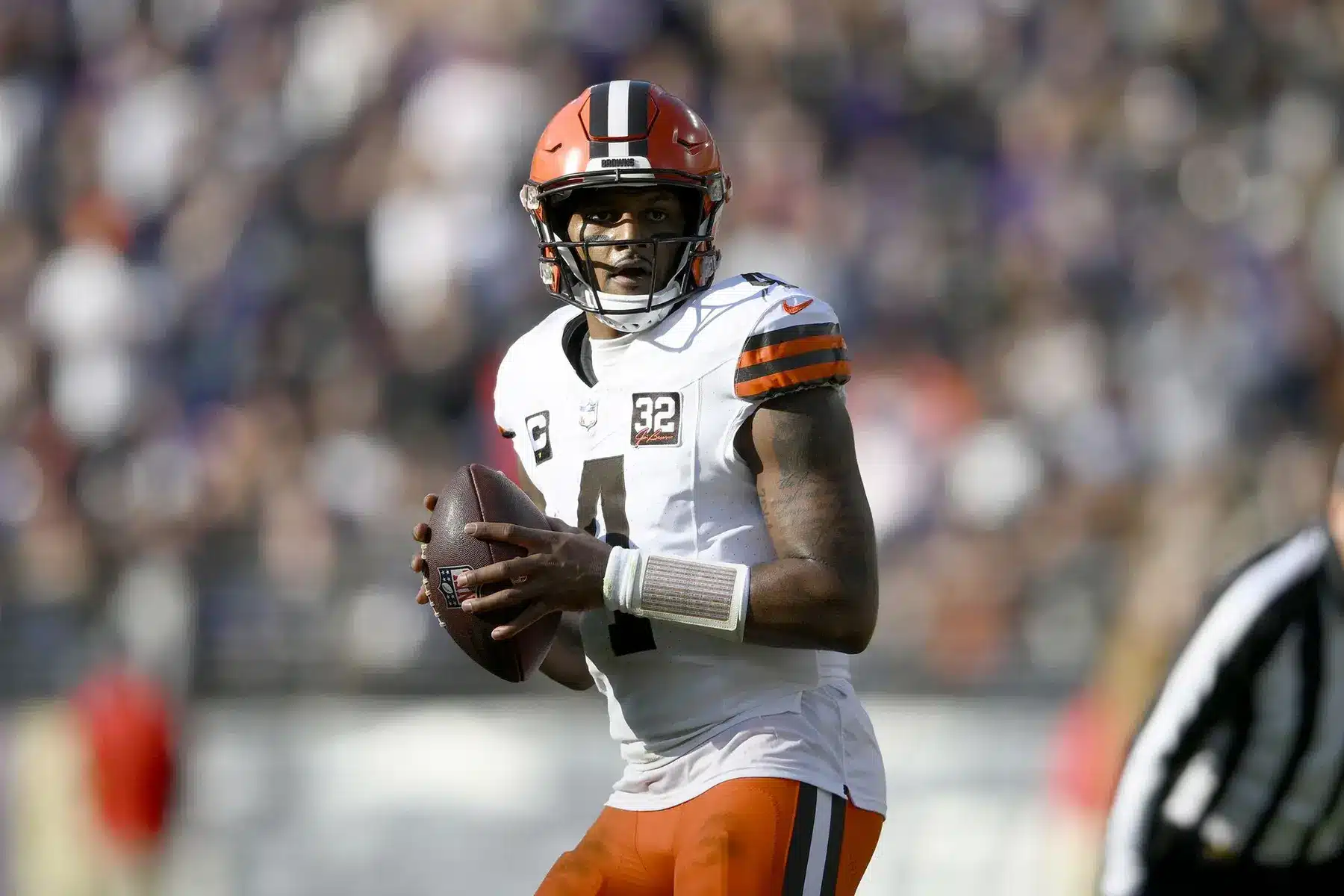 Deshaun Watson in Cleveland Browns uniform preparing to pass the football during a game.