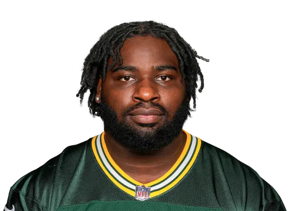 Devonte Wyatt wearing a Green Bay Packers jersey with a focused expression.