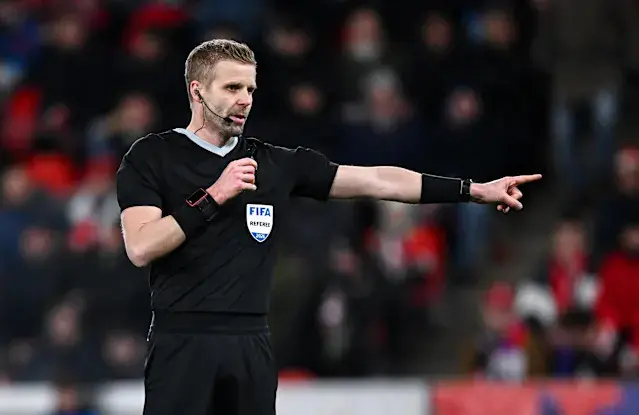Glenn Nyberg officiating a soccer match, wearing a FIFA referee kit.