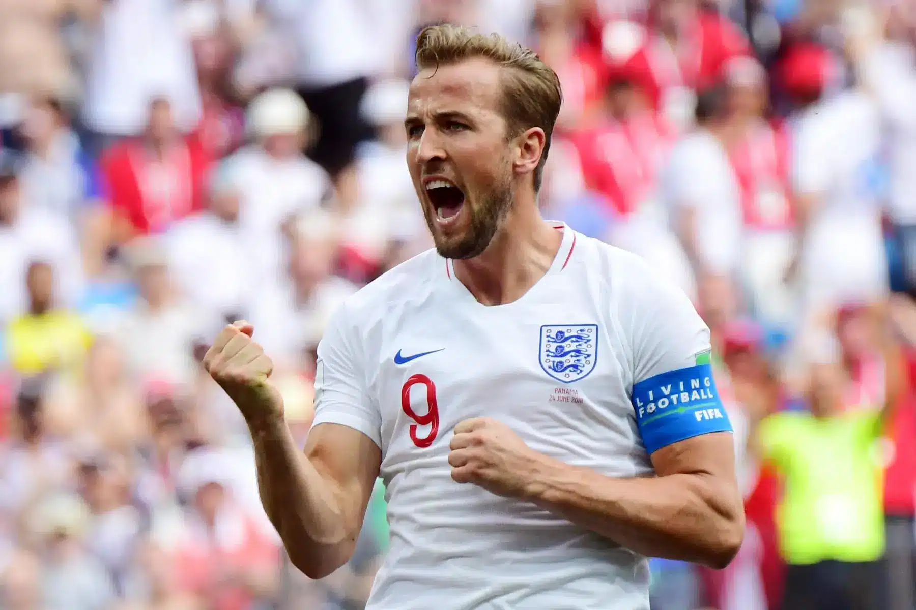 Harry Kane celebrating a goal during a football match with England.
