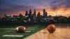 Football and basketball on Philadelphia sports venue surfaces with city skyline at sunset