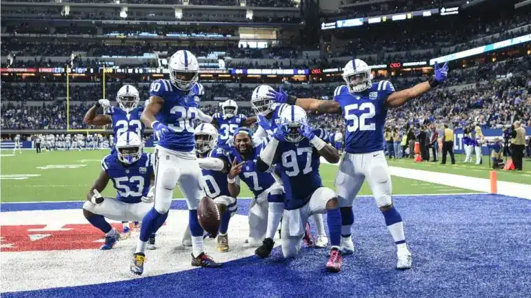 Indianapolis Colts defense celebrating after a play during an NFL game.