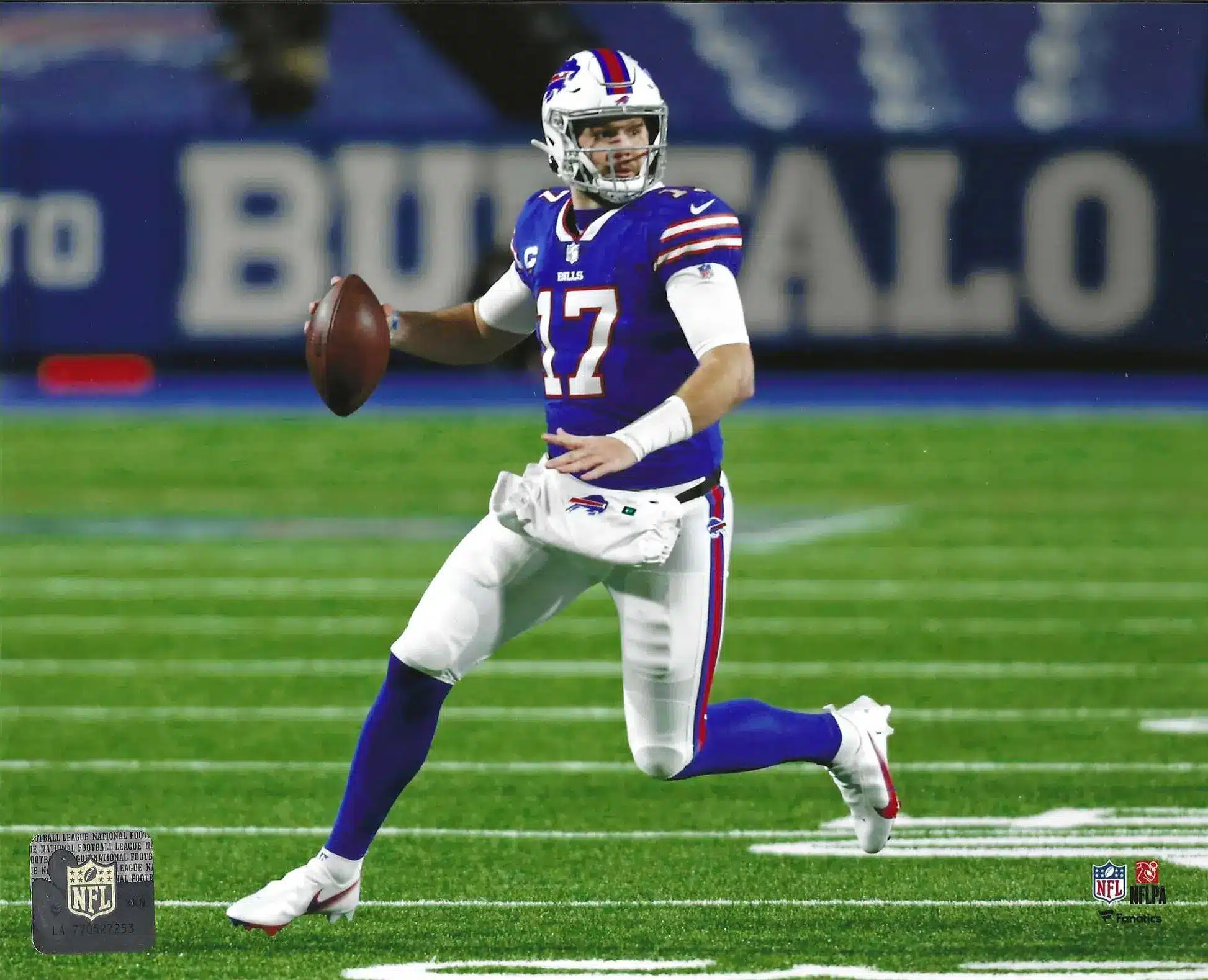 Josh Allen in blue Buffalo Bills uniform throwing a football on the field.